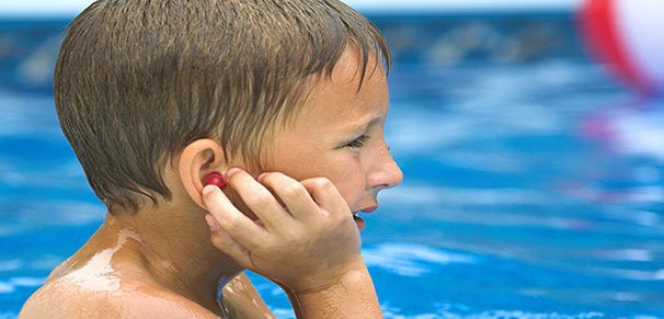 Boy in a pool with swimmers ear