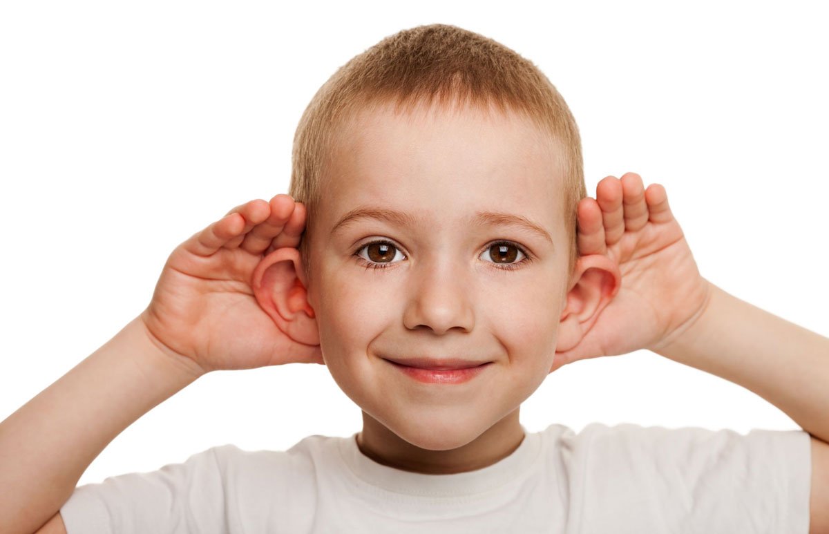 Little boy cupping his hands behind his ears