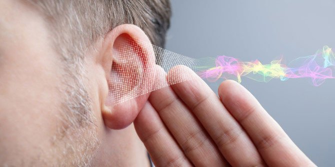 Person with their hand up to their ear and graphic of sound coming into the ear