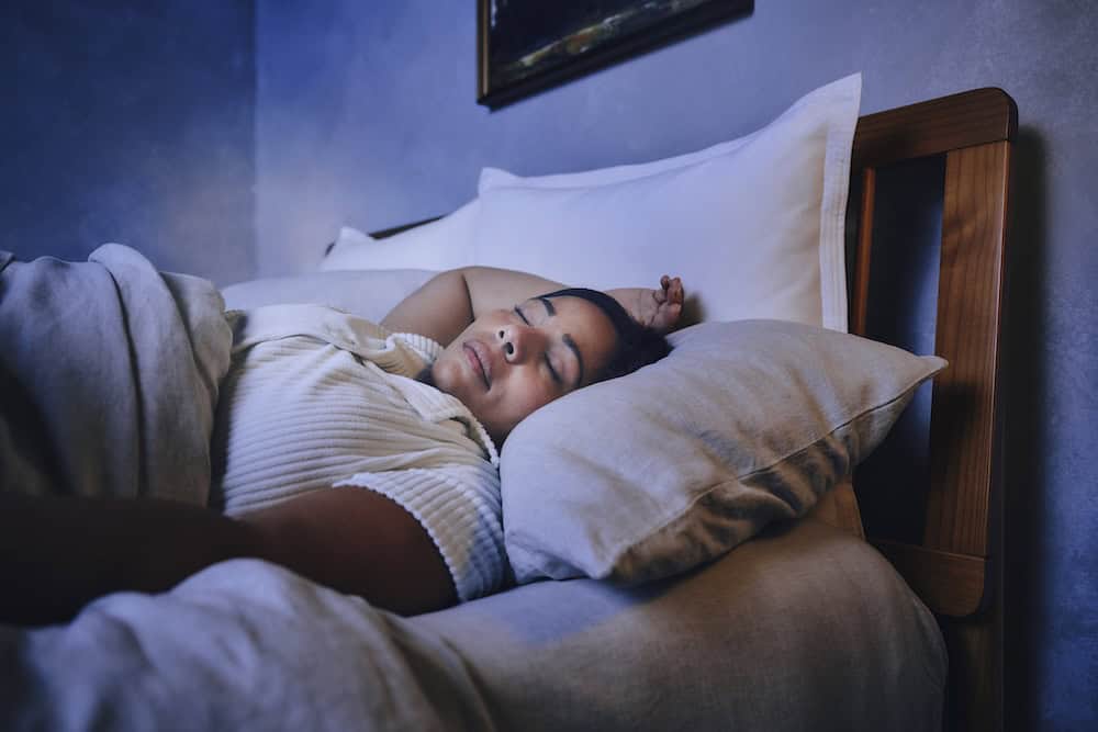 A woman sleeping peacefully in bed